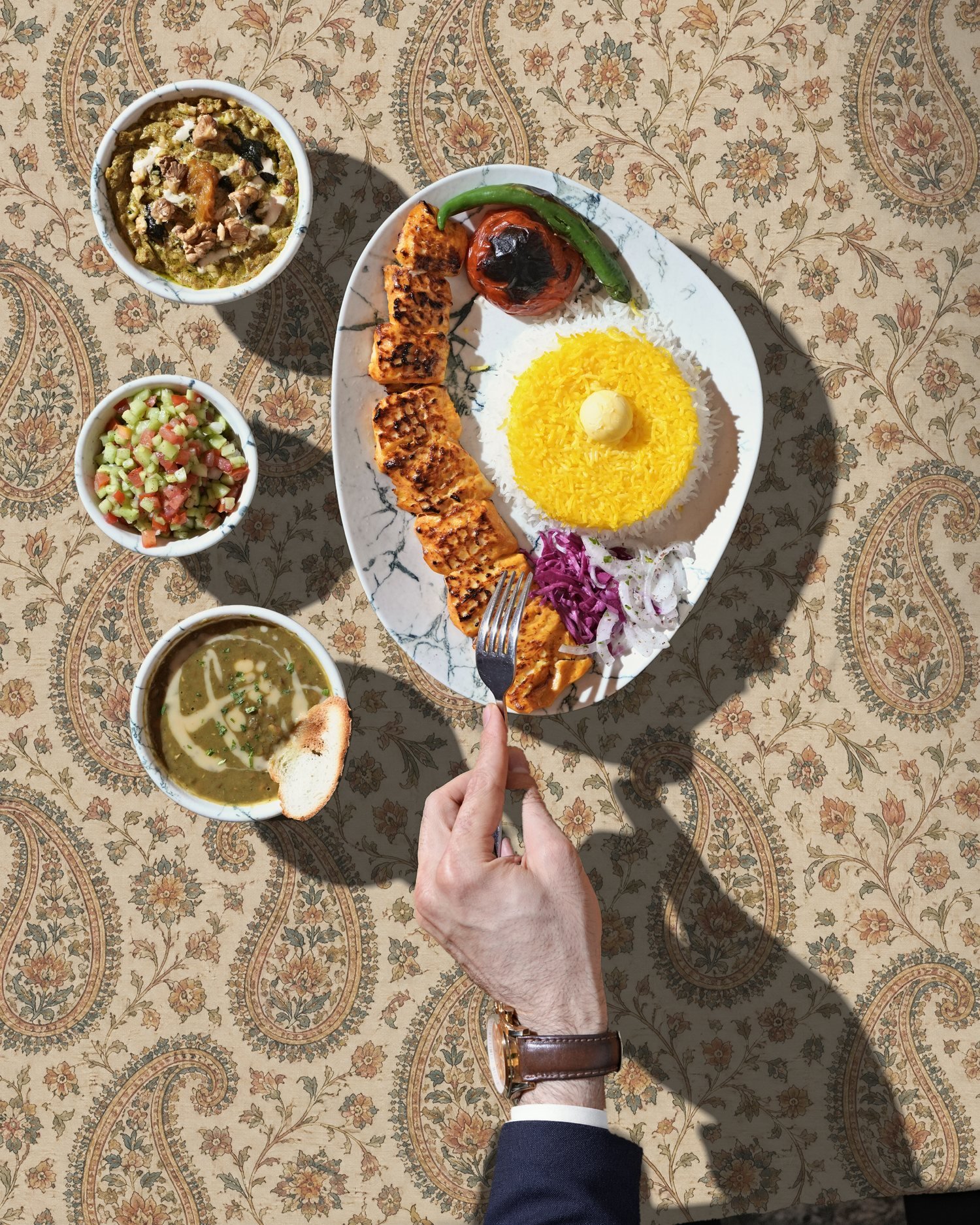 Business Lunch from above on beige termeh: Chicken Kebab with saffron rice, Kashke Bademjan, Shirazi Salad and Lentil Soup